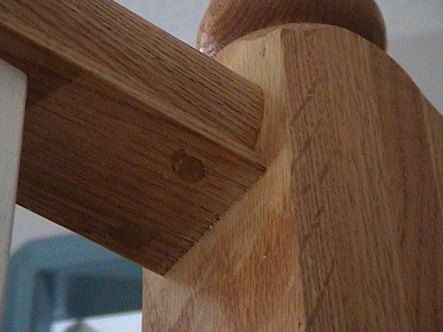 Photo of the details of how the top rail of a balustrade joins the newel post.
